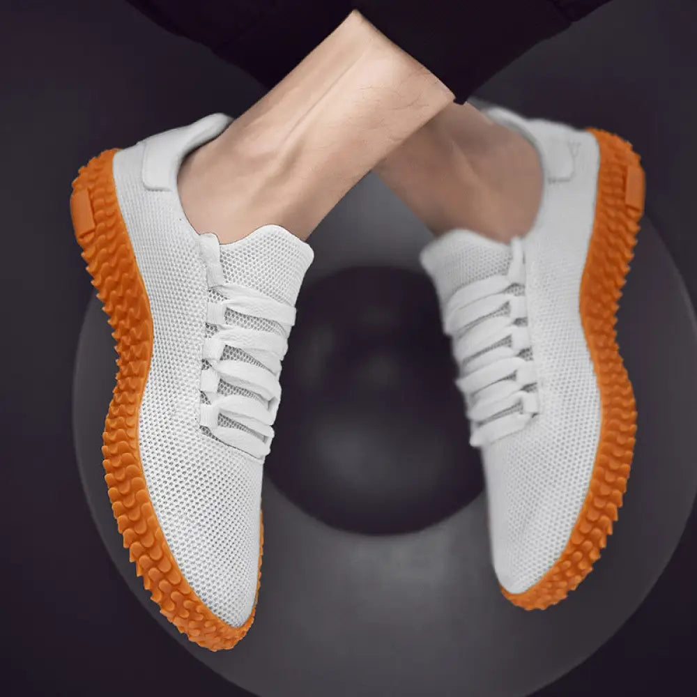 Men’s breathable flying woven mesh korean sneakers with white mesh upper and vibrant orange rubber soles and laces