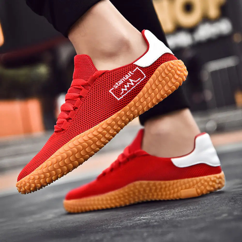Men’s breathable flying woven mesh Korean sneakers in red with white accents and a textured orange sole