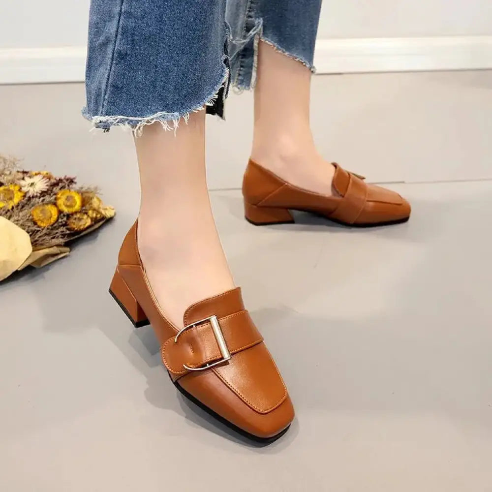 Brown leather square toe loafers with a silver buckle in classic slip-on style for formal and casual wear