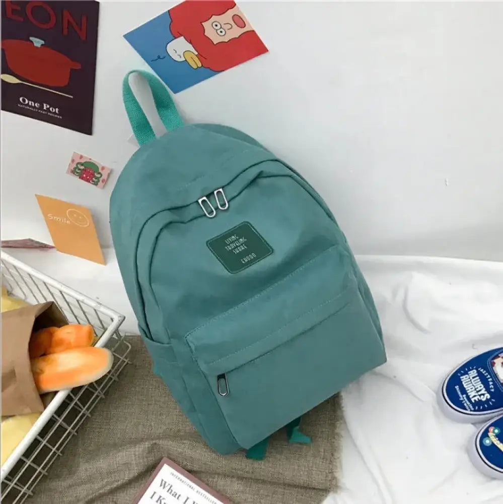 Teal canvas women’s Korean corduroy pastel school and travel backpack with green fabric straps and front rectangular patch
