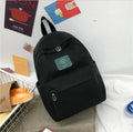 Black canvas women’s Korean corduroy backpack with green patch and silver zipper pulls for school and travel use
