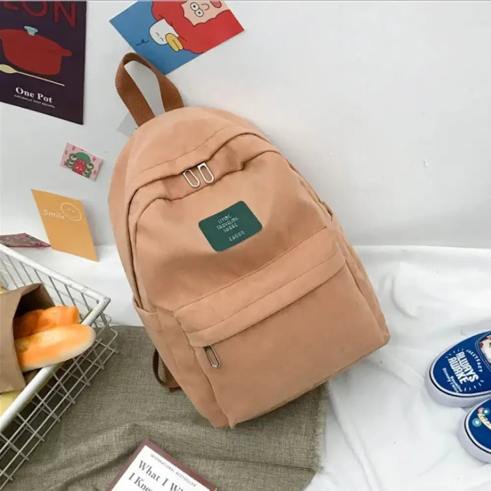 Beige canvas women’s Korean corduroy pastel school and travel backpack with brown straps and green rectangular patch