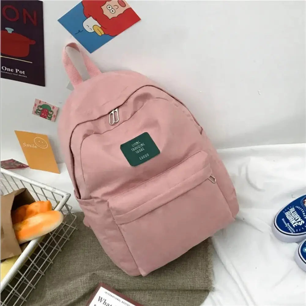 Pink canvas womens korean corduroy pastel school and travel backpack with green patch and silver zipper pulls