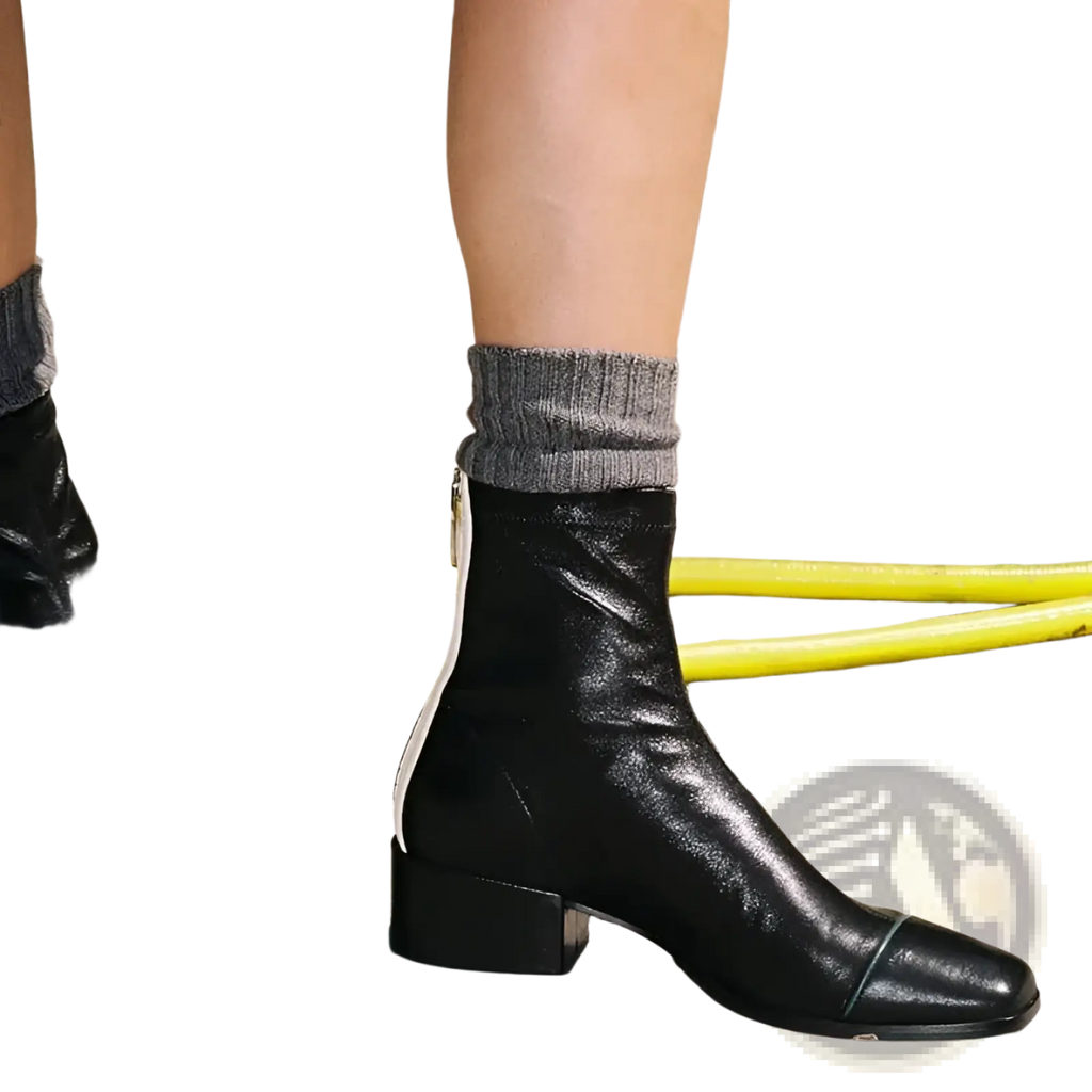 Black leather square toe ankle boots with low block heel and white contrast zipper on the inner side