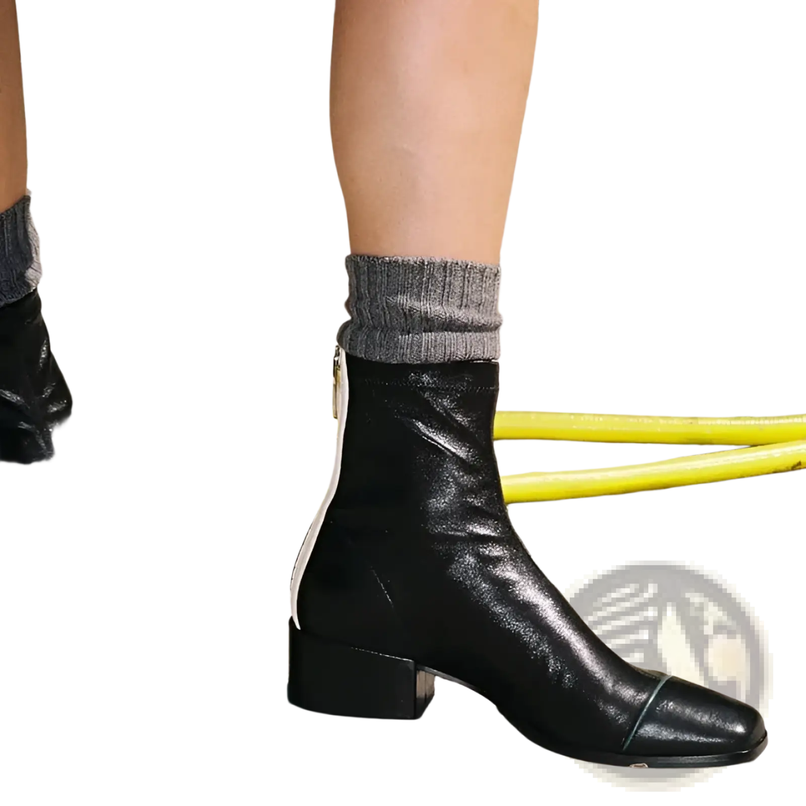 Black leather square toe ankle boots with low block heel and white contrast zipper on the inner side