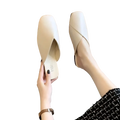 Cream-colored square toe flat leather mules featuring a sleek minimalist design and soft leather upper