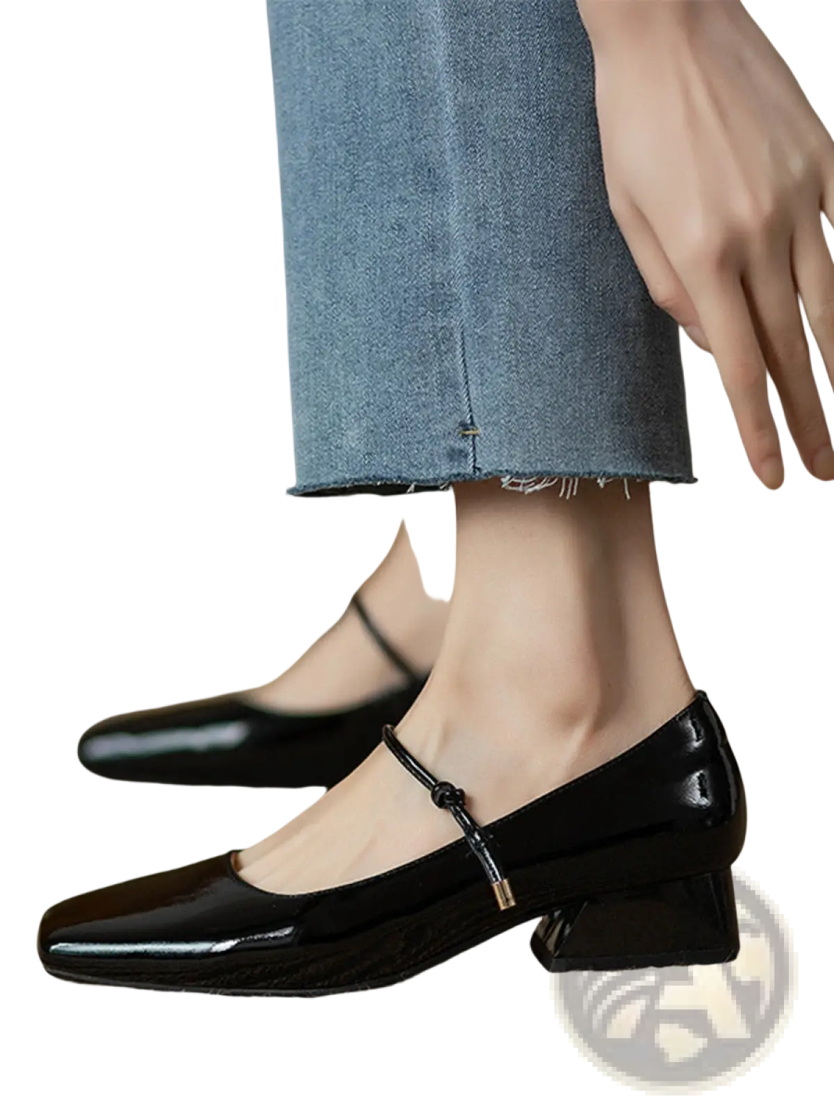 Black patent leather square toe mary jane flats with low block heel and metallic buckle strap across instep