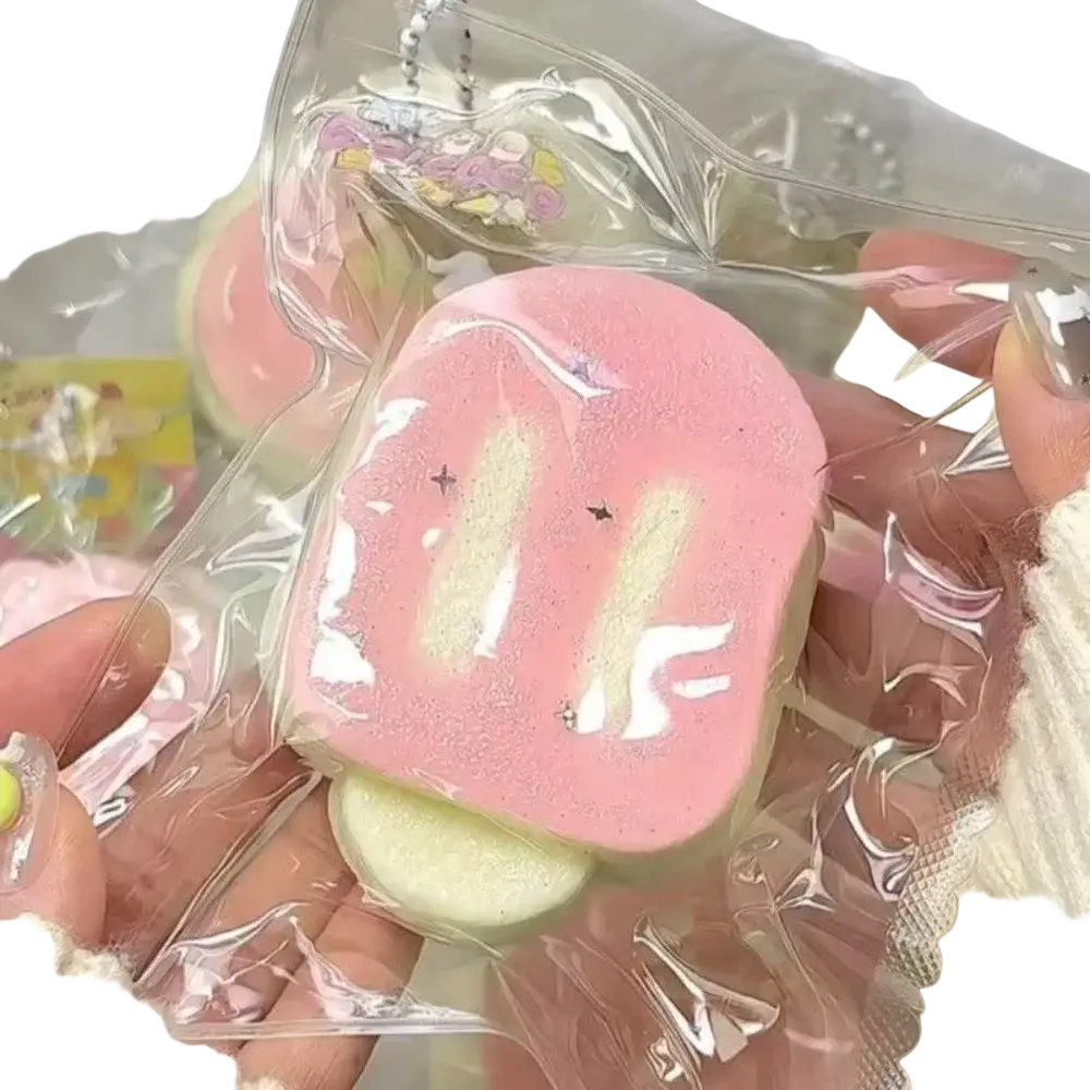 Pink and white marshmallow-shaped slow rising squeeze toy with glittery details for stress relief and sensory play