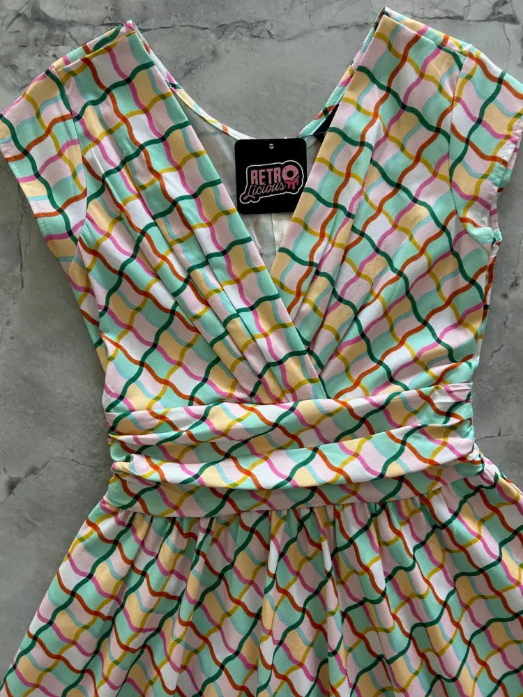 Squiggly Greta vintage cotton V-neck dress with pockets in a vibrant sleeveless pastel wavy grid pattern on white