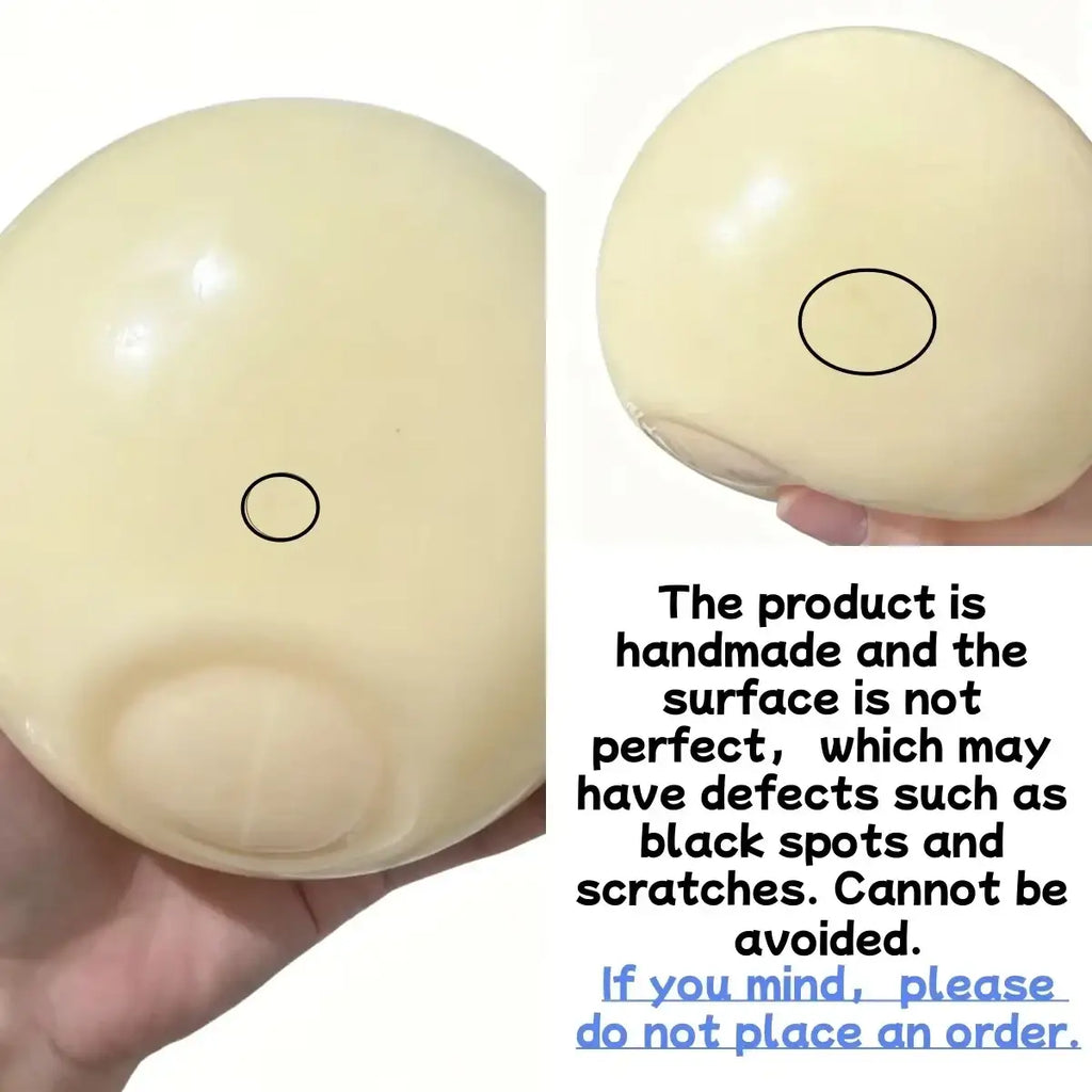 Cream-colored glossy handmade squishy ball with a smooth surface for stress relief and sensory toy use