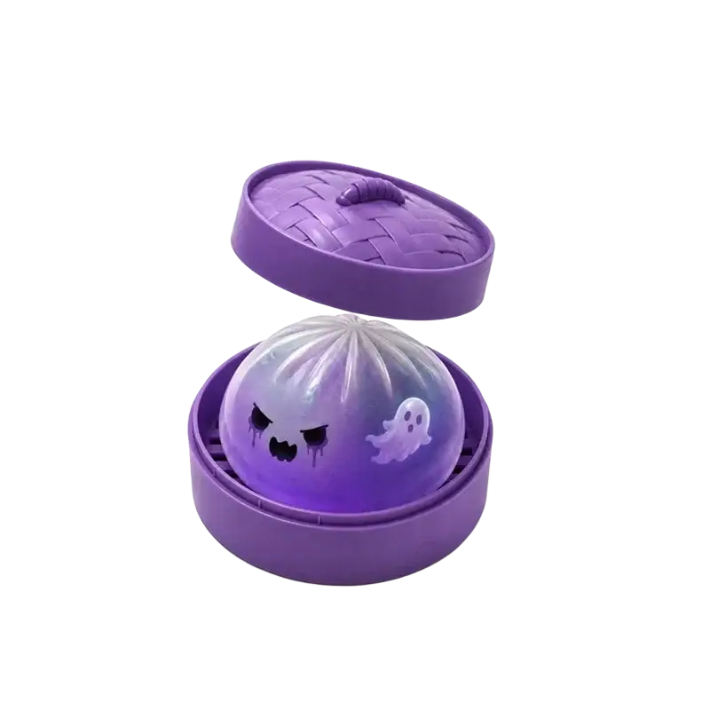 Purple plastic steamer containing a translucent ghost-faced squishy dumpling stress ball finished goods product
