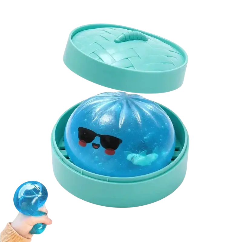 A translucent blue squishy dumpling stress ball with black sunglasses and red cheeks in a teal steamer basket finished goods
