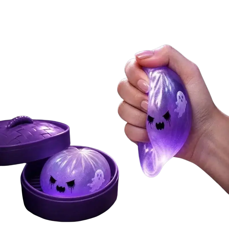 A translucent purple glowing ghost-shaped squishy dumpling stress ball with black eyes and white ghost decals finished goods