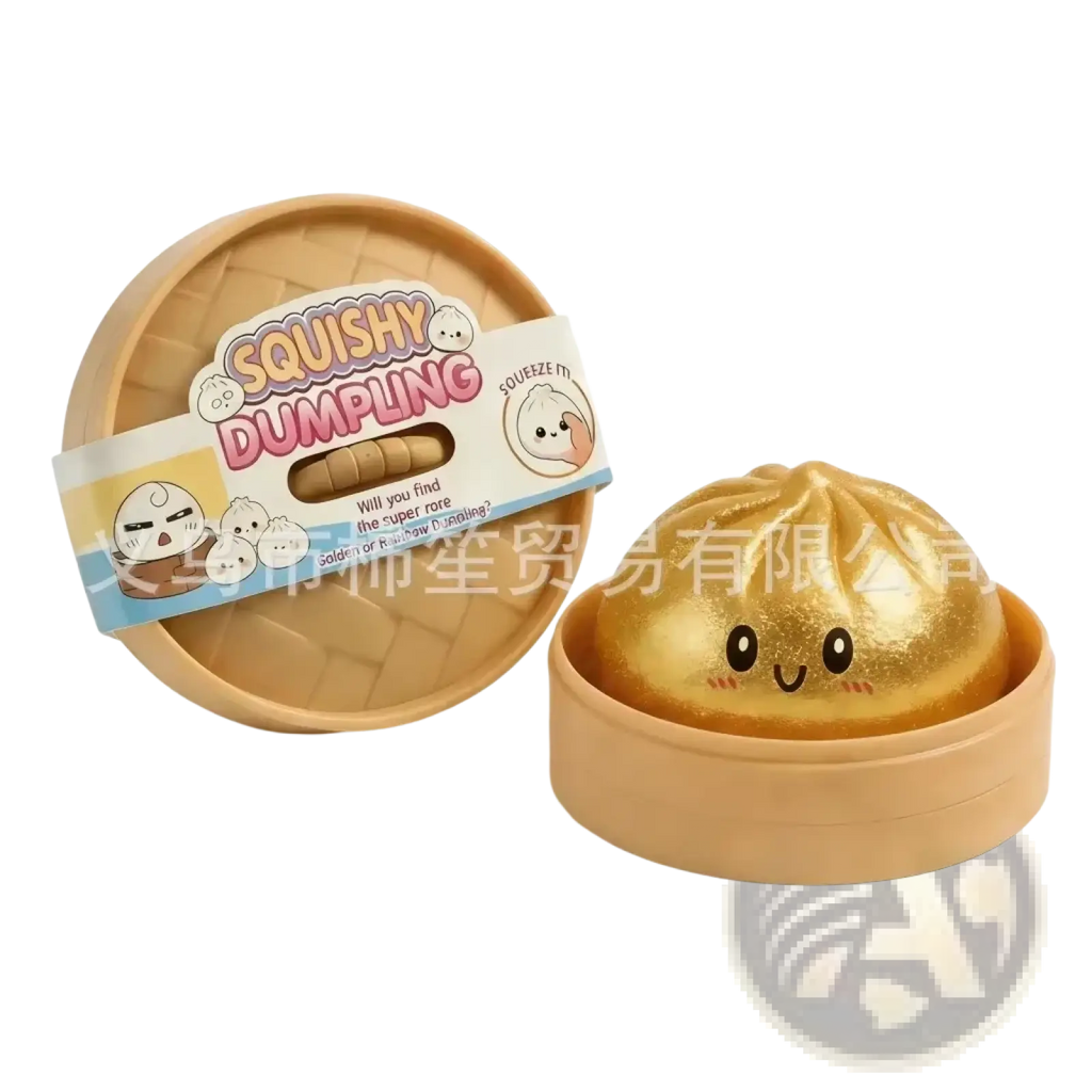 Golden squishy dumpling stress relief toy with a shiny glittery surface and a cute cartoon face design