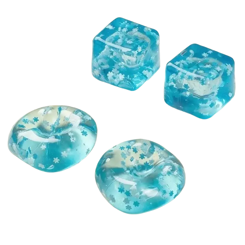 Blue translucent squishy snowflake ice cubes with white flower patterns shaped like ice blocks and round orbs