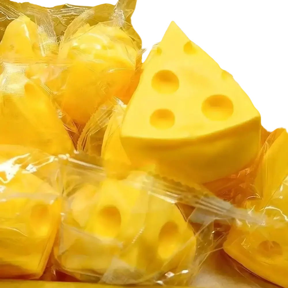 Yellow cheese-shaped squishy stress ball and sensory toy wrapped in clear plastic with characteristic holes