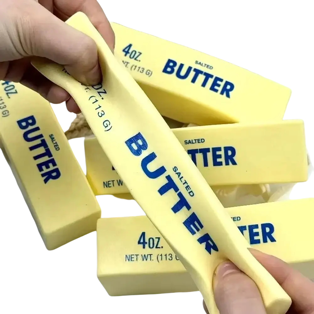 Yellow salted butter sticks labeled 4oz in blue text in a squishy stress ball and sensory toy set