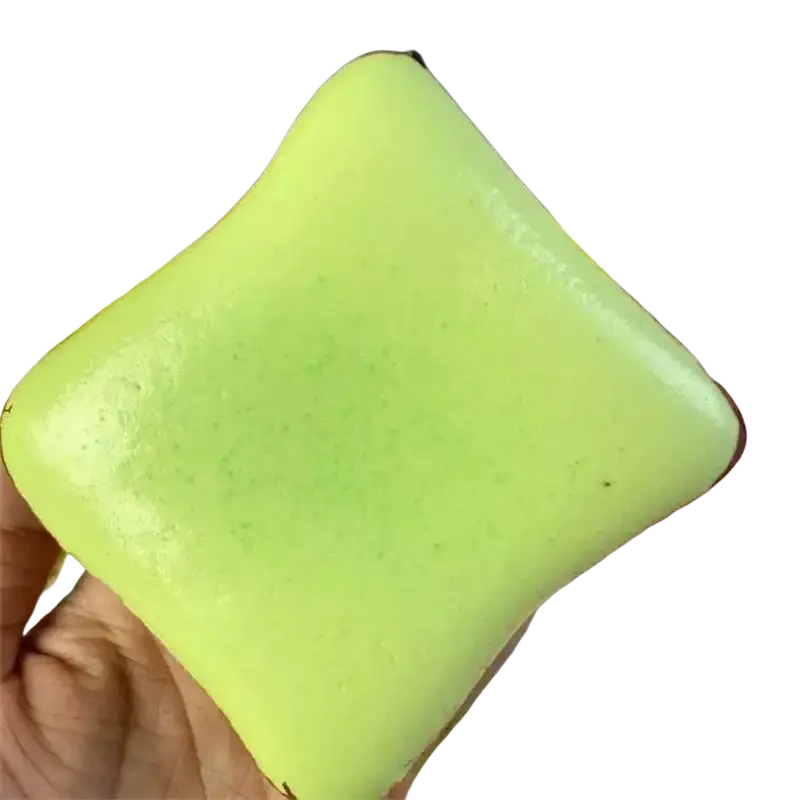 A smooth lime-green square-shaped squishy toast stress relief toy with a glossy finish and rounded edges