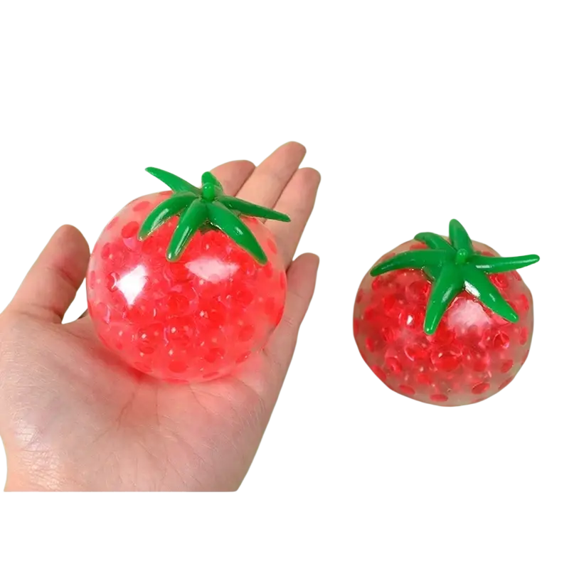 Red tomato-shaped squishy stress relief toy with green leafy top and translucent gel beads inside for squeezing