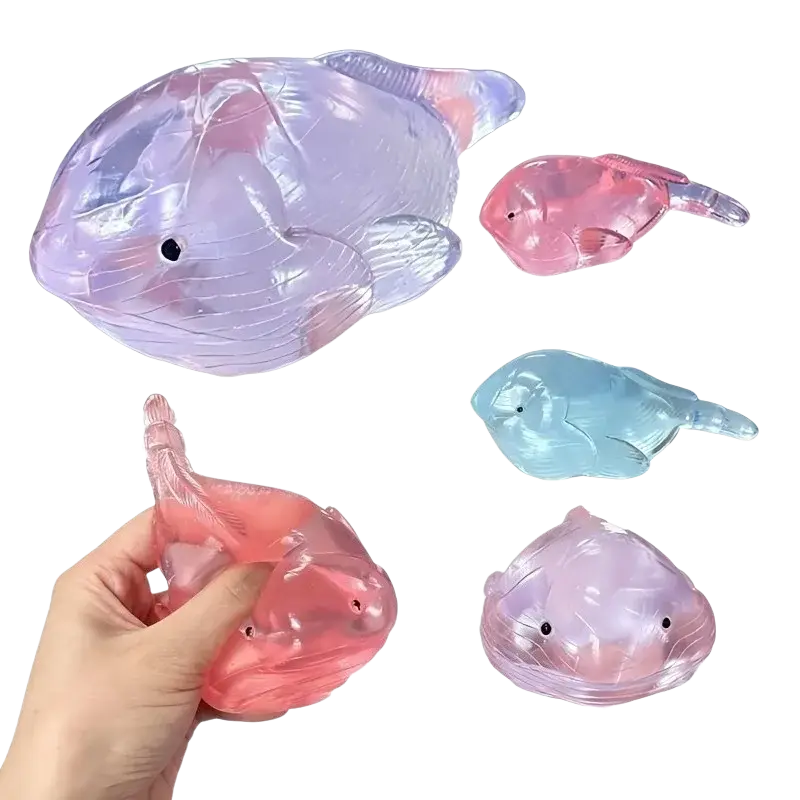 Transparent iridescent fish-shaped squishy whale fidget toy stress balls in pastel pink and blue hues