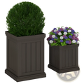 Dark brown stackable pp planter with vertical paneling and efficient drainage holes holding lush green shrubbery