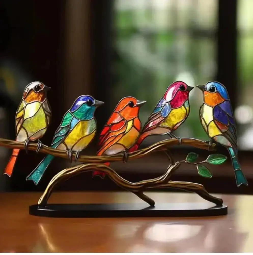 Vibrant stained glass bird figurine set in colorful hues perched on bronze branch with green leaves home decor
