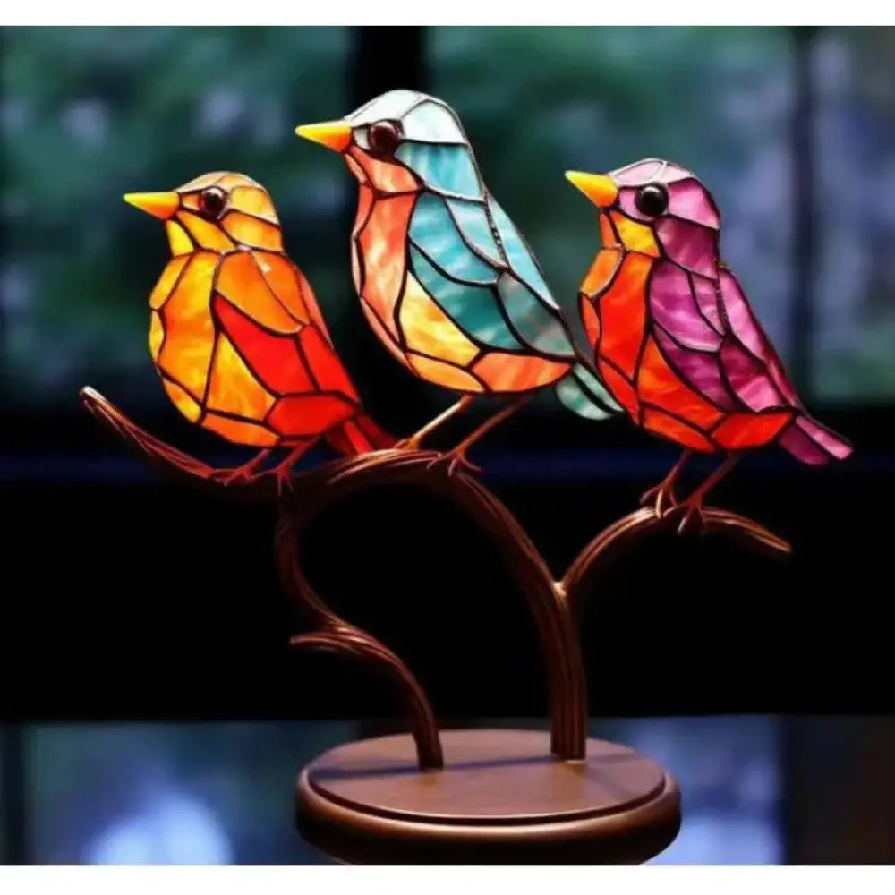 Vibrant stained glass birds in orange teal and pink perched on a dark wooden branch figurine for home decor