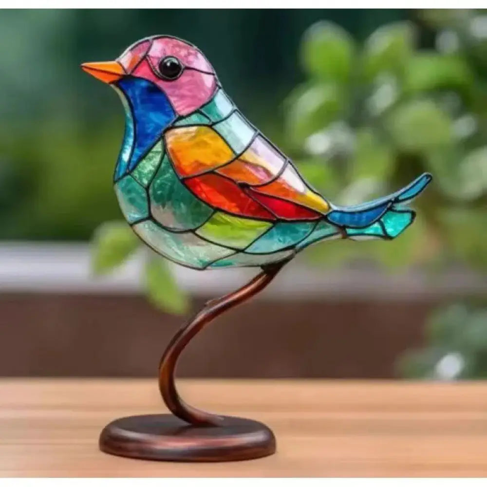 A vibrant stained glass bird figurine with a pink head, blue neck, and multicolored wings for home decor