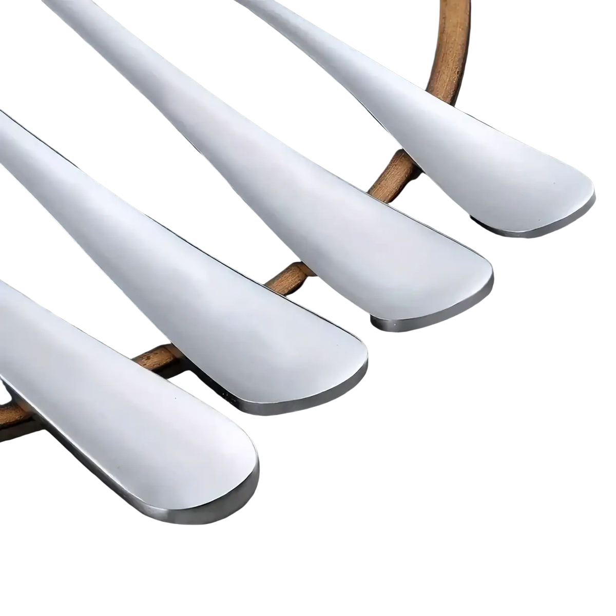 Set of four sleek modern stainless steel spoons with polished handles in a 16-piece cutlery set