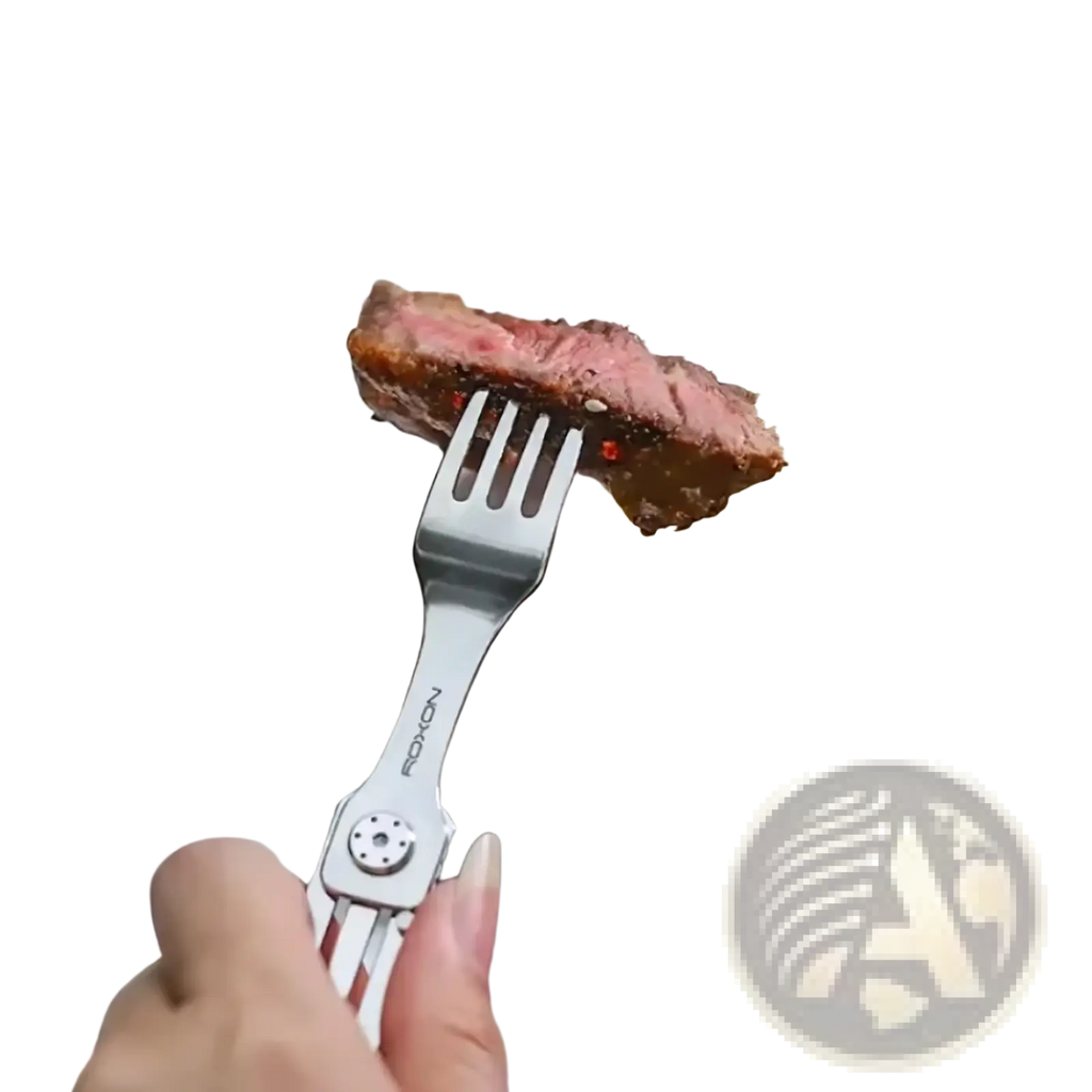 A sleek silver-toned stainless steel 3-in-1 camping cutlery fork holding a slice of medium-rare steak