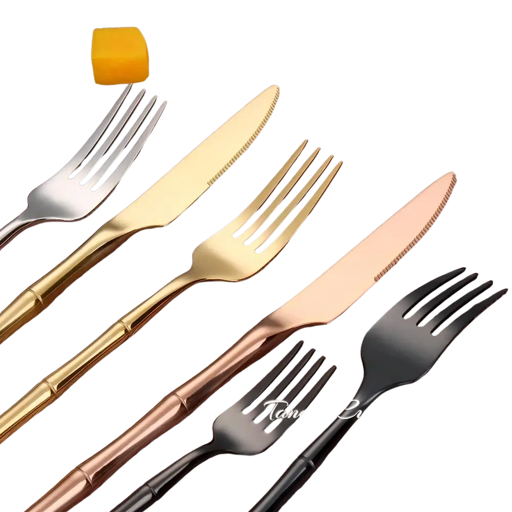 Set of four stainless steel bamboo cutlery pieces with gold rose gold and black handles in modern design