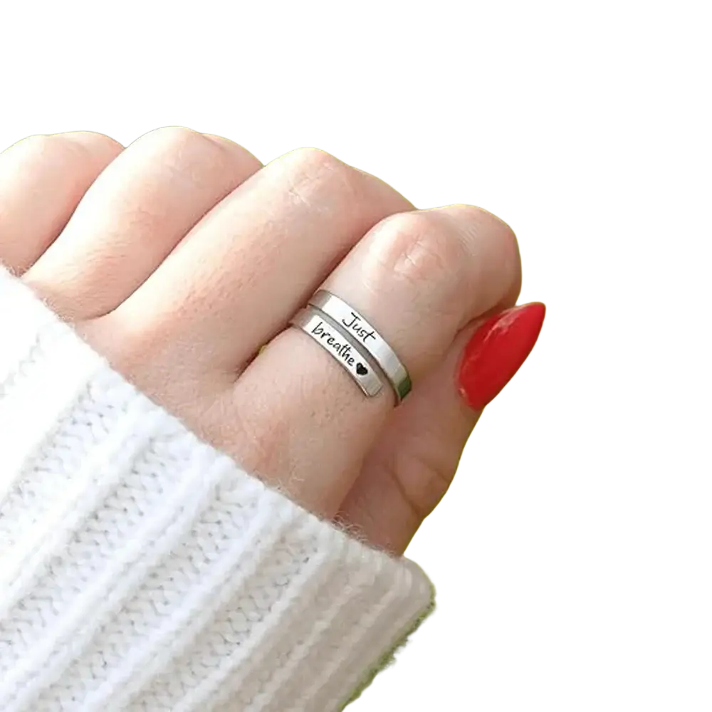 Stainless steel silver wrap-around anxiety ring with just breathe inscription and small heart symbol