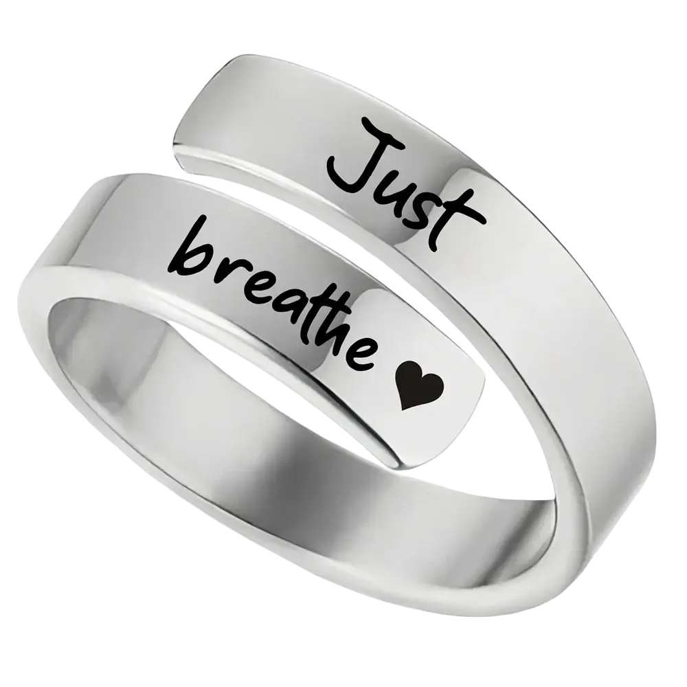 Stainless steel silver wrap-around ring engraved with just breathe in black script and a small heart symbol