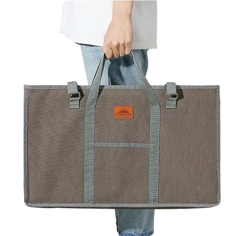 Brown canvas storage bag with gray striped handles and orange patch for stainless steel camping table outdoor furniture