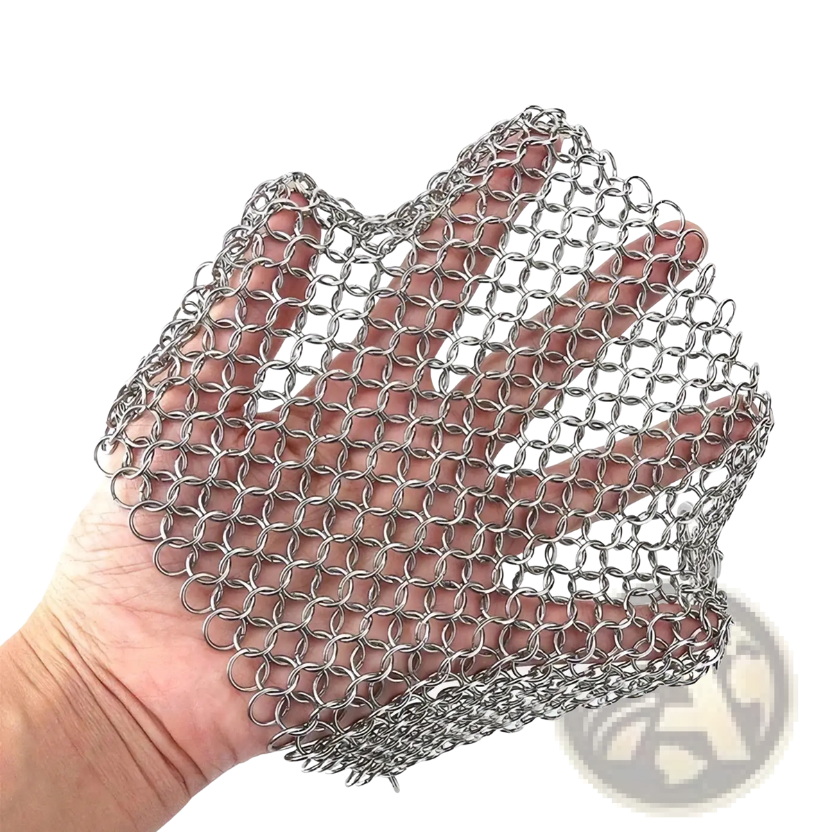 A hand holds a flexible silver stainless steel chainmail glove for cleaning cast iron pots
