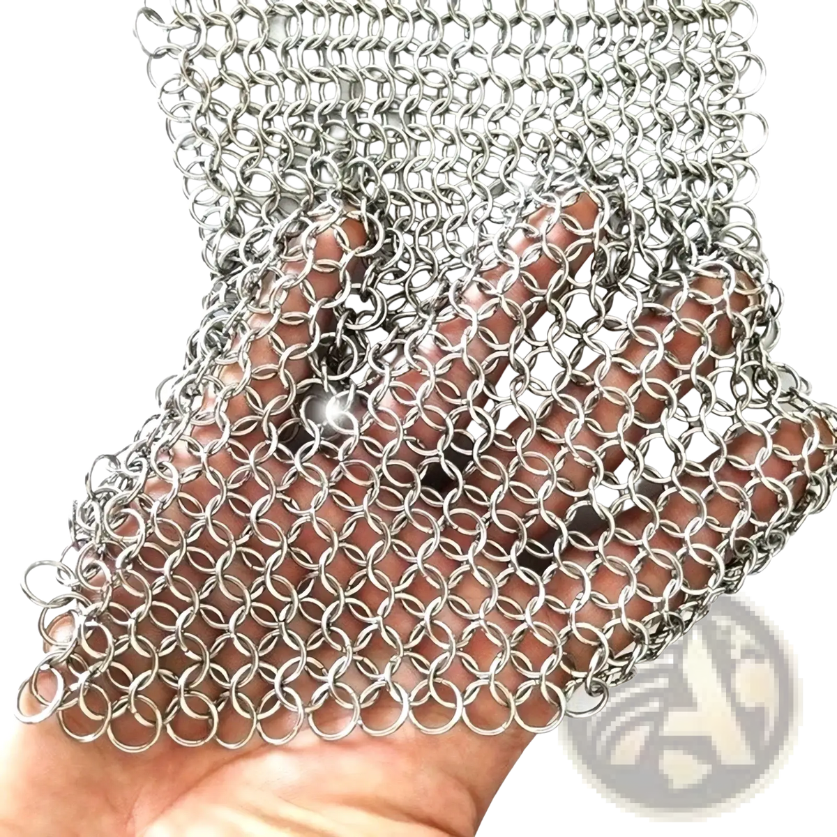 A hand holds a silver-toned stainless steel chainmail pot scrubber with interlocking circular rings