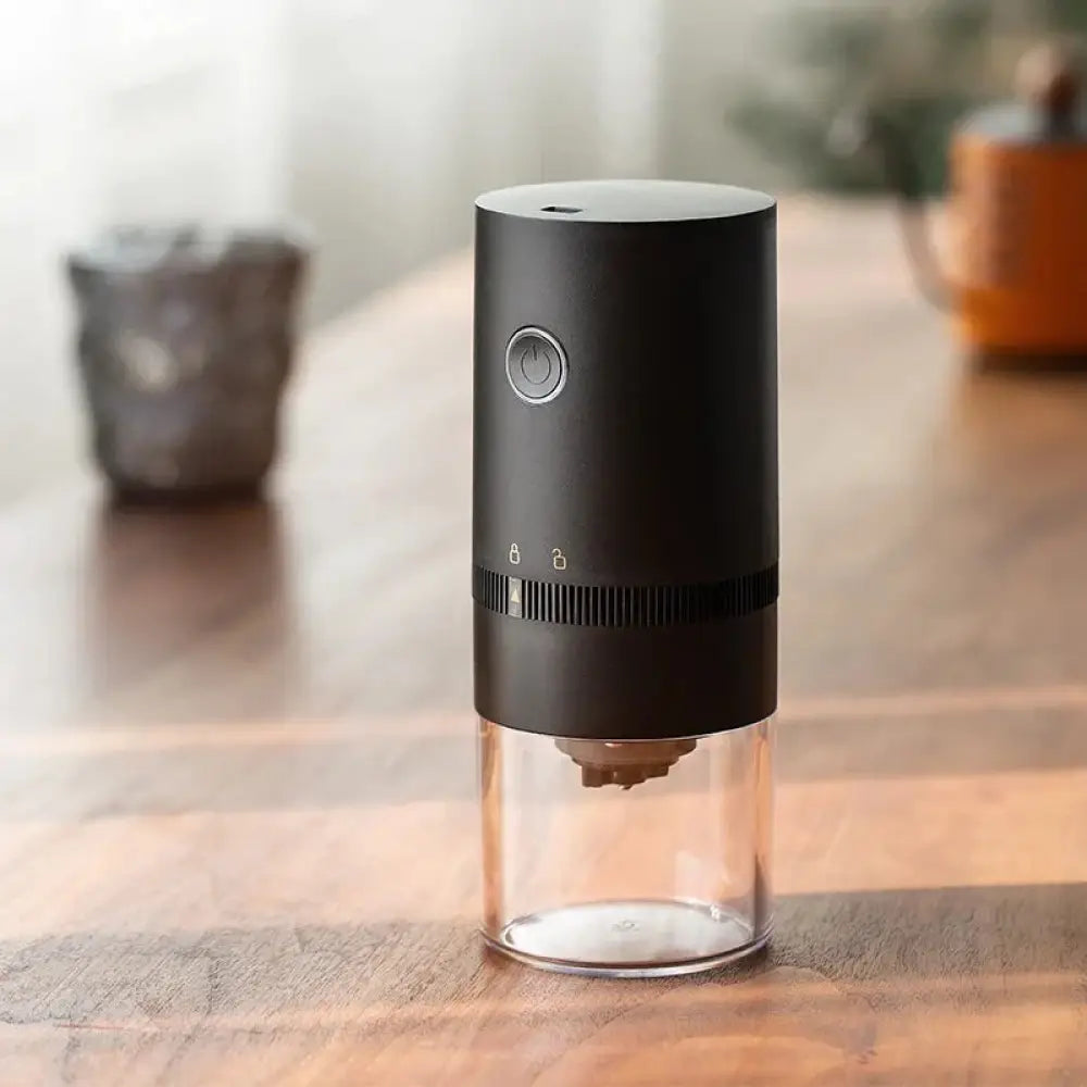 Premium stainless steel electric coffee grinder in black with a clear glass base for efficient grinding