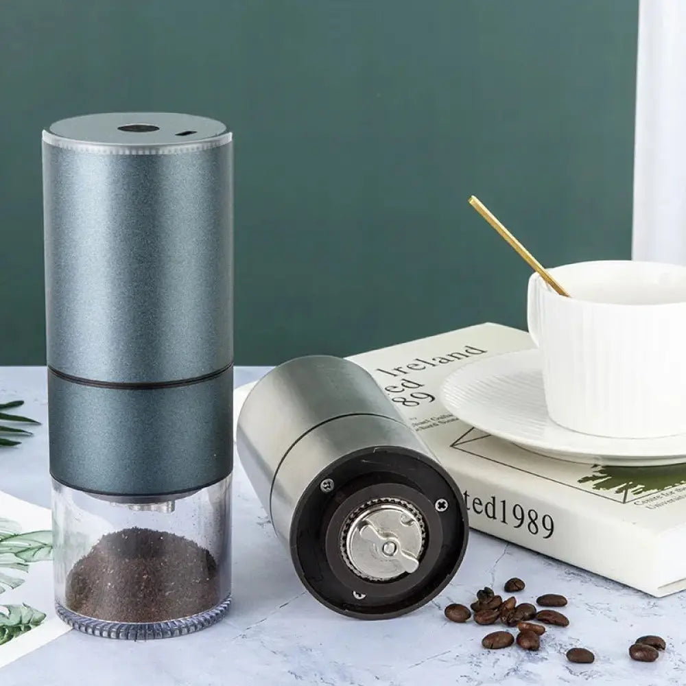 Silver premium stainless steel electric coffee grinder with glass base holding ground beans and black internal mechanism