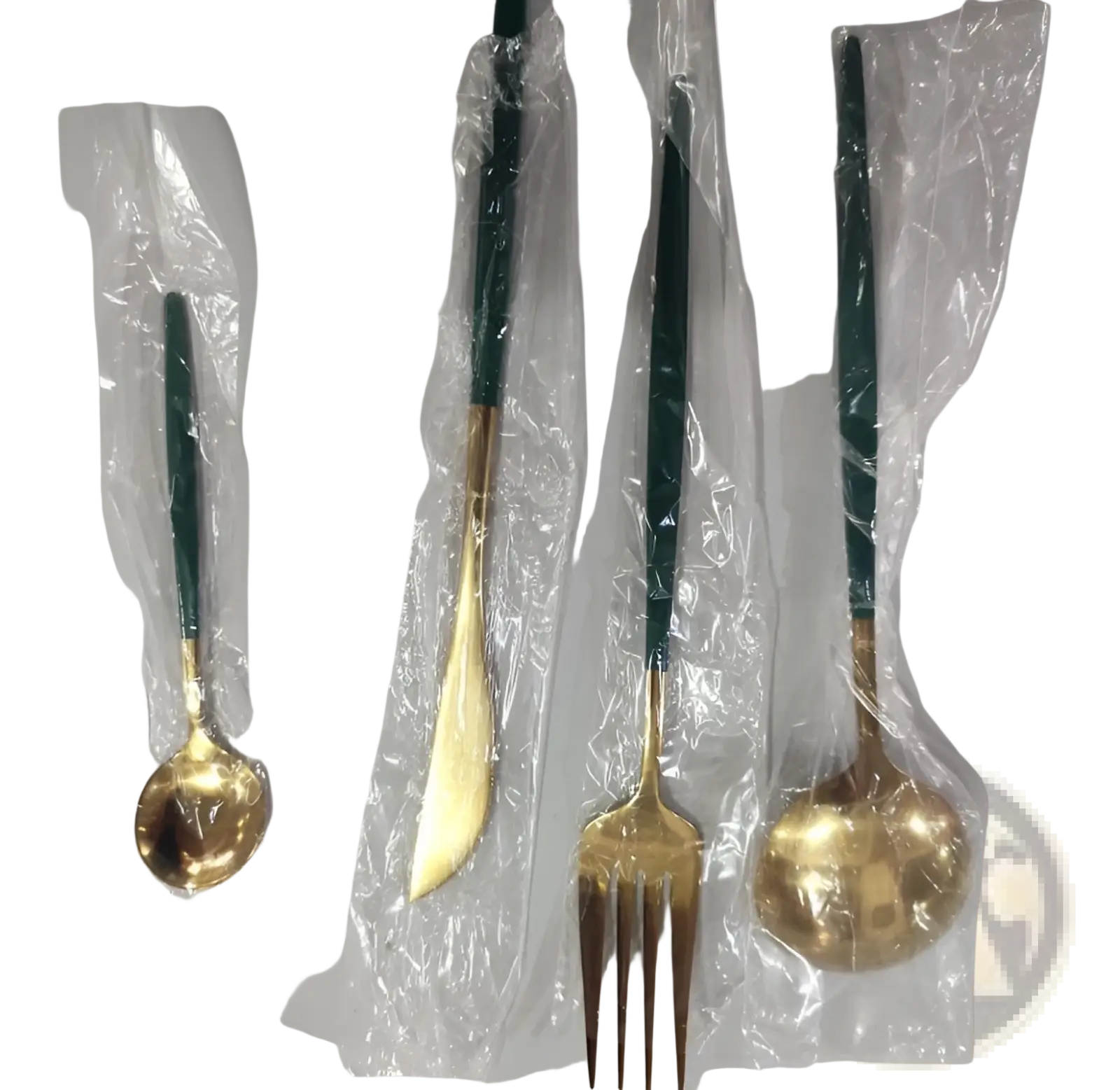 Set of four stainless steel cutlery pieces with gold-toned blades and dark green handles wrapped in clear plastic