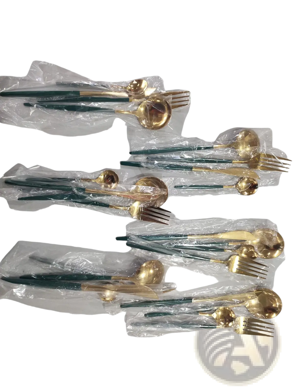 Set of stainless steel cutlery with elegant gold-toned blades and dark green handles neatly packaged in clear plastic
