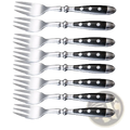 Set of eight stainless steel forks with black handles featuring white dot accents in polka dot flatware design