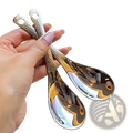 Shiny silver stainless steel dessert spoon set with teardrop shape and hammered texture handles