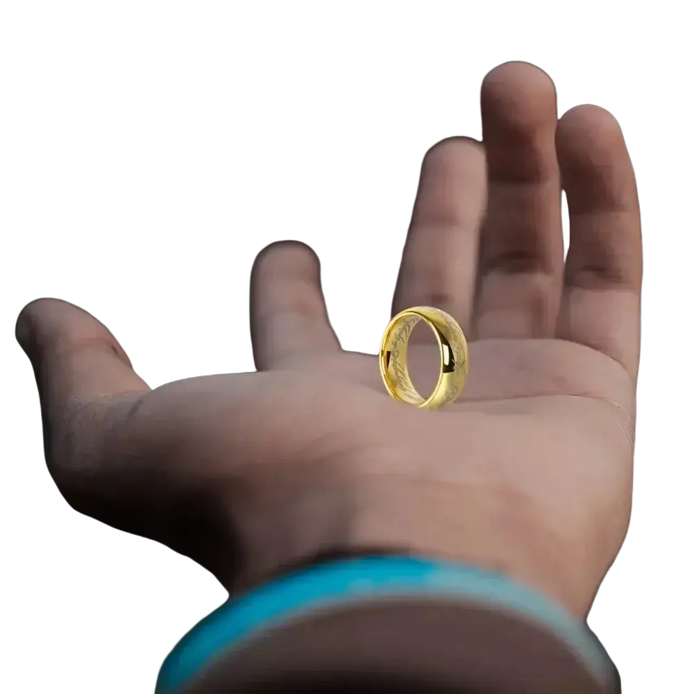 A golden stainless steel elvish script wedding band ring with intricate engravings displayed on an open palm