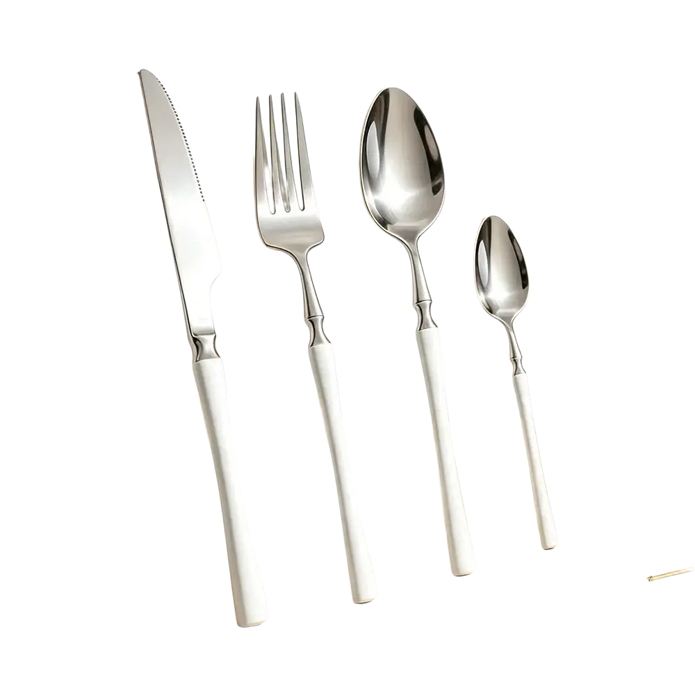 Set of four stainless steel flatware pieces with sleek white handles and polished modern design