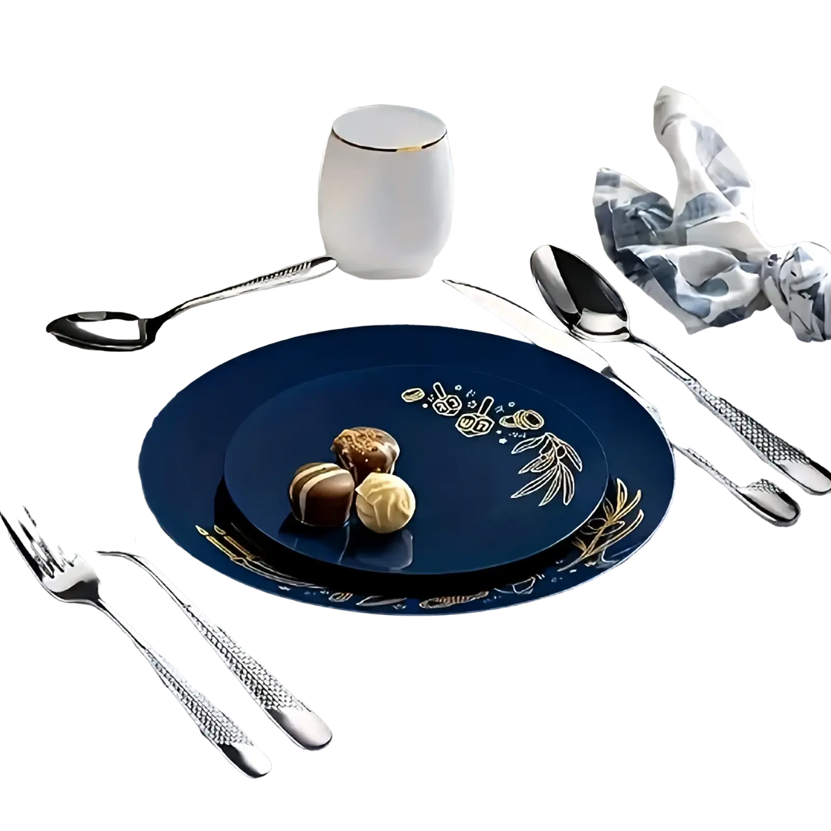 Deep blue ceramic plate with gold leaf floral and fruit motifs paired with stainless steel flatware set 40 piece on table