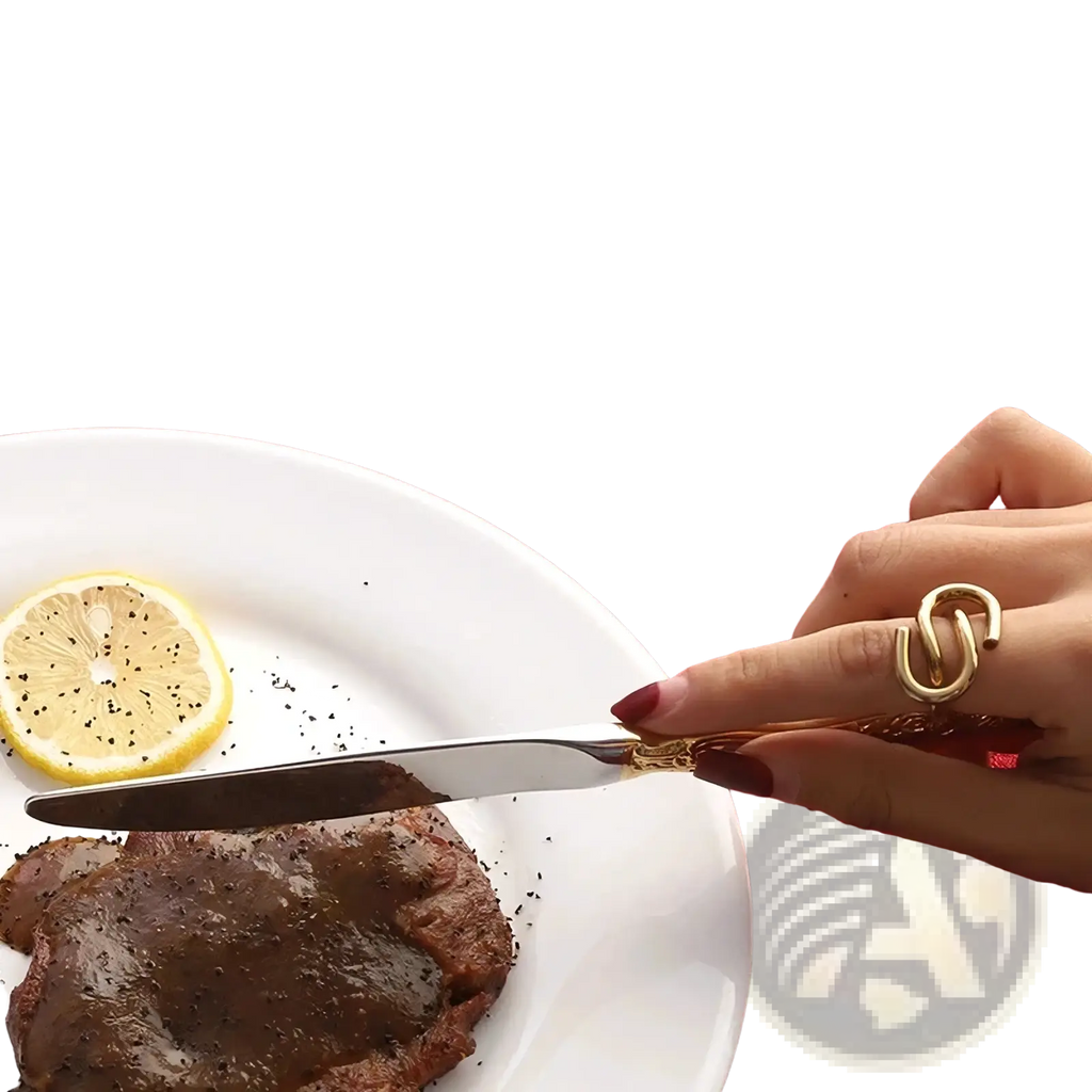 Gold-handled stainless steel main knife with sleek round head and sharp blade from flatware set gold inlaid cutlery