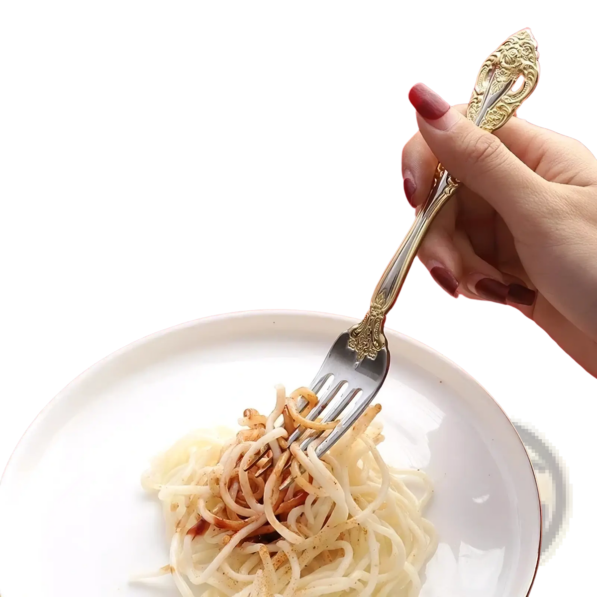 An ornate gold-handled stainless steel fork with intricate filigree holding spaghetti with savory sauce