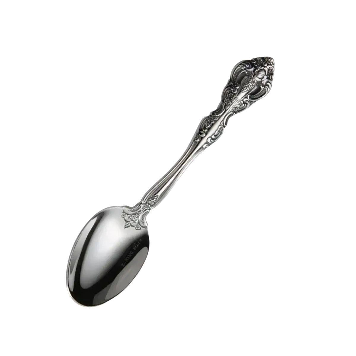 Silver dessert spoon with ornate vintage handle and reflective bowl from stainless steel flatware set gold inlaid cutlery