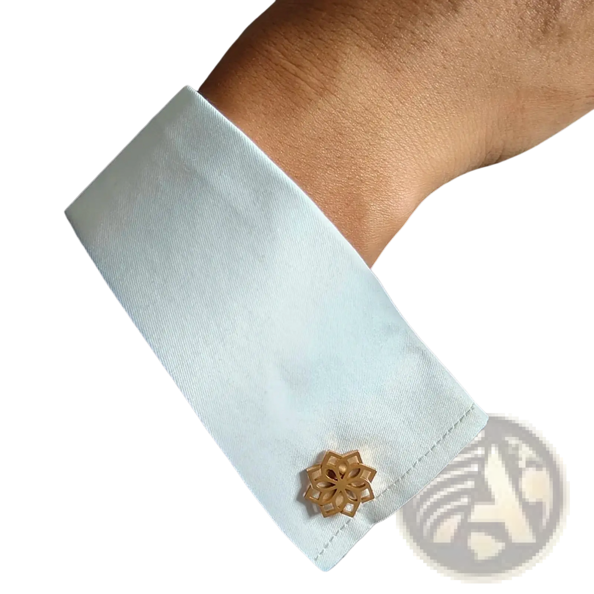 Gold-toned stainless steel floral cufflink with intricate cut design on a white shirt cuff for men
