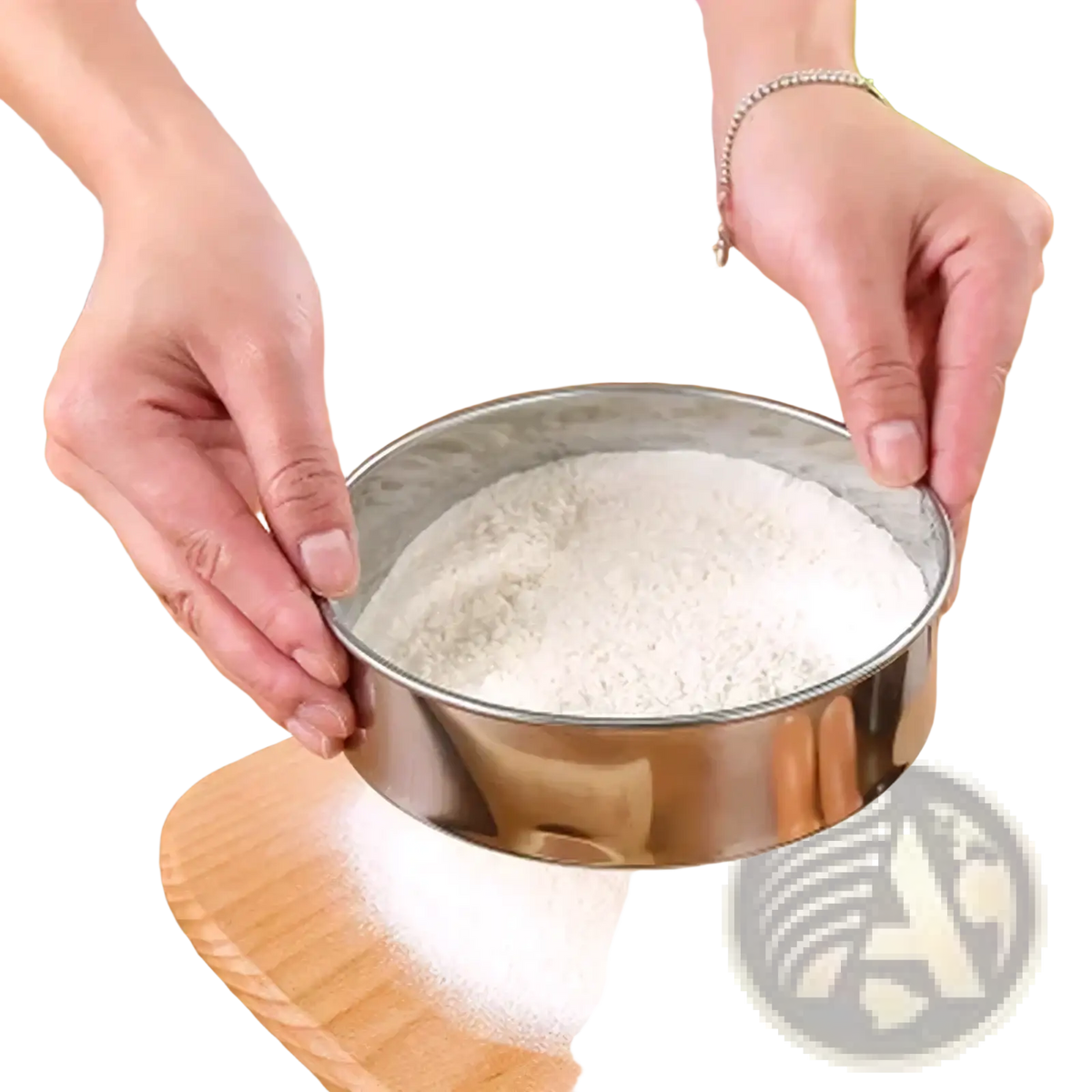 Circular stainless steel flour sifter with hammered texture sifting white flour onto wooden board for baking use